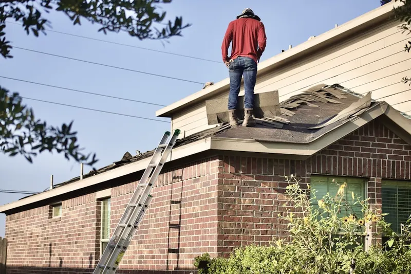 Professional roofer working on a residential roof in Cambridgeport